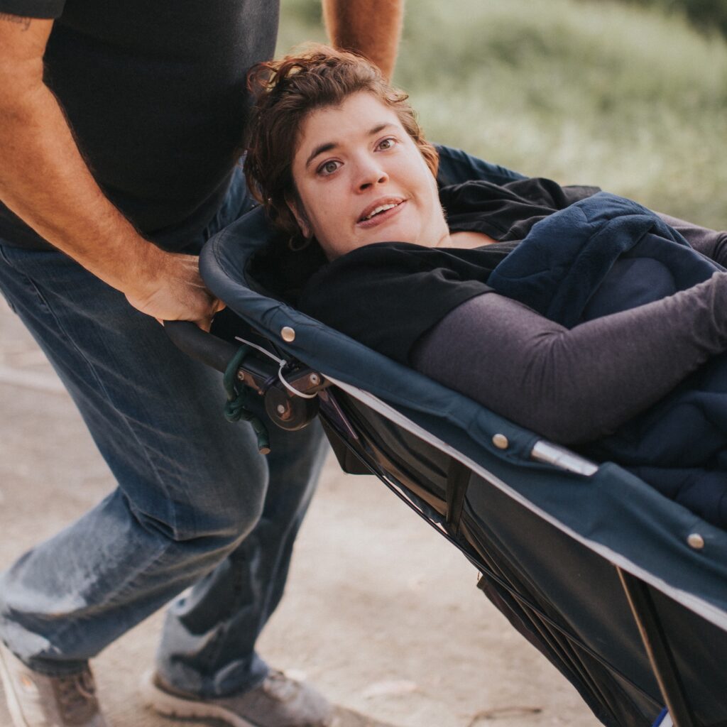 Woman staying warm in a wheelchair with a battery powered heating blanket